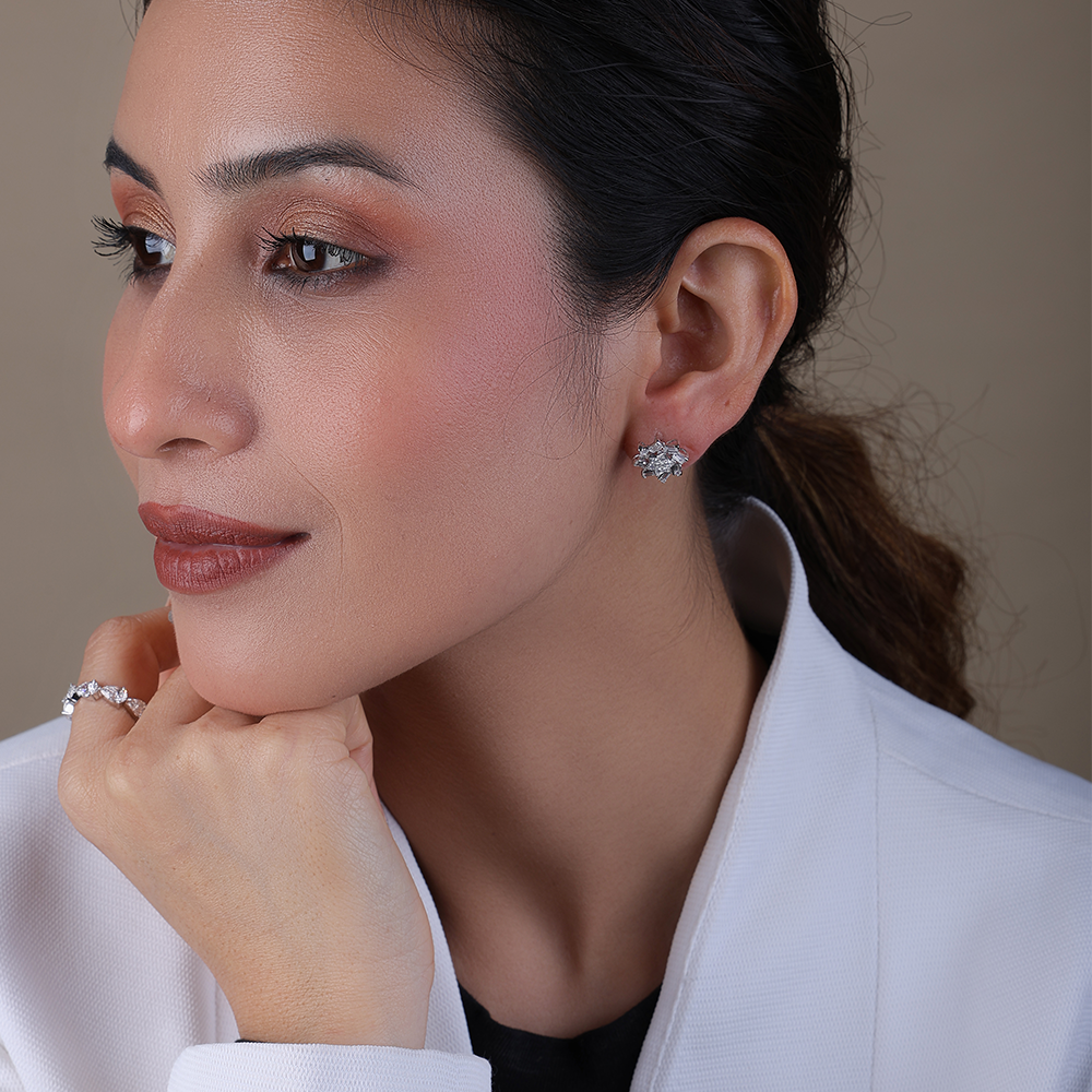 Snowflake-inspired stud earrings with baguette and round Diamonds