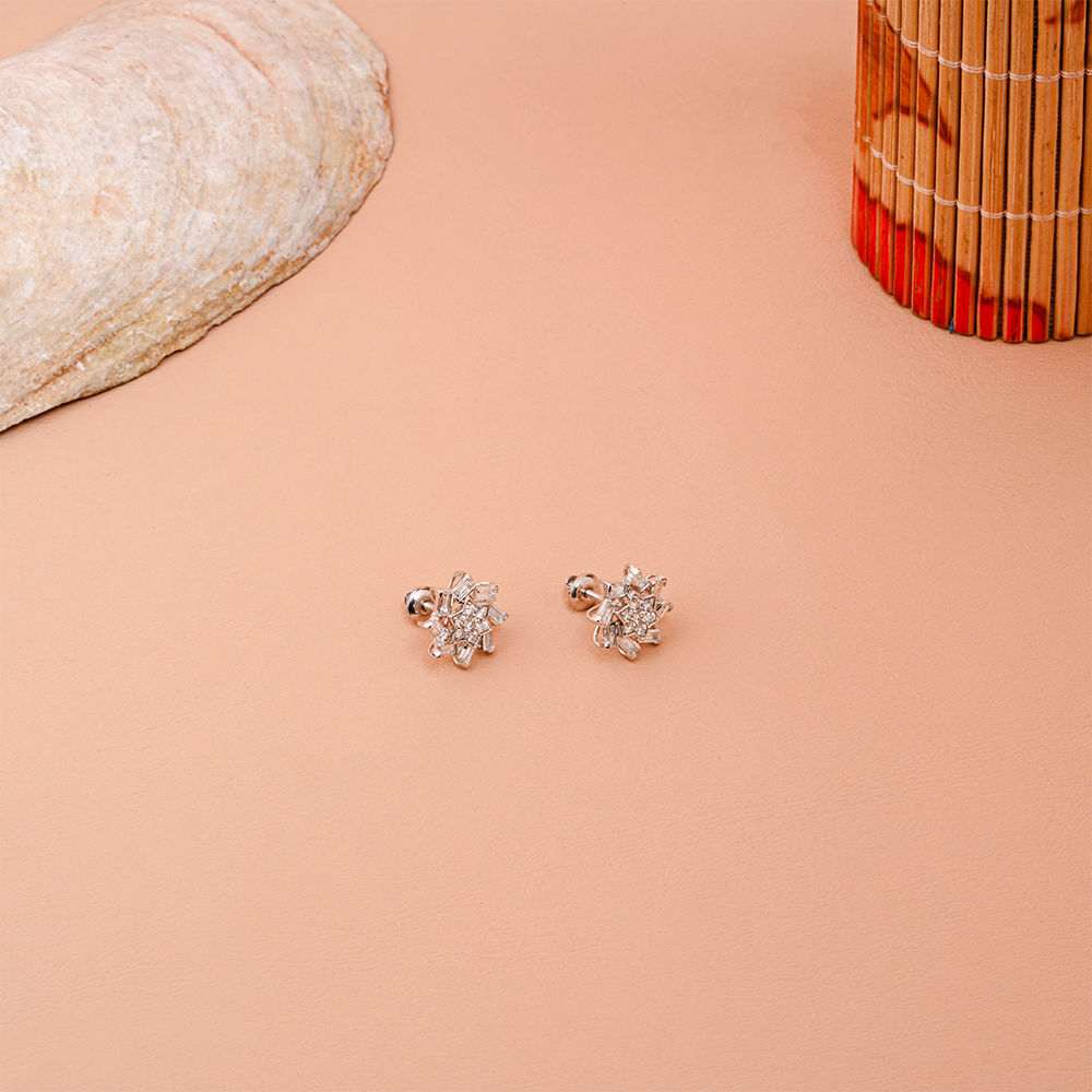 Snowflake-inspired stud earrings with baguette and round Diamonds