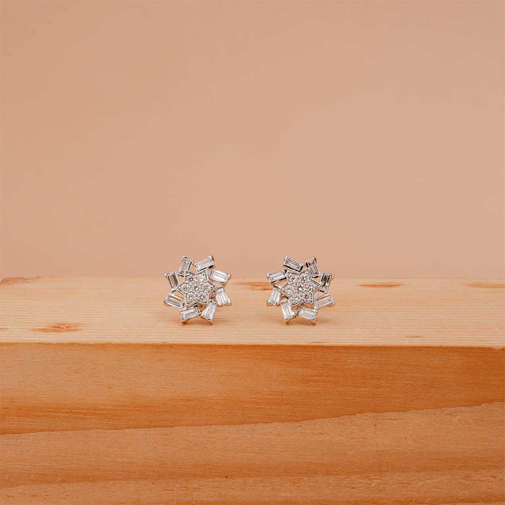 Snowflake-inspired stud earrings with baguette and round Diamonds