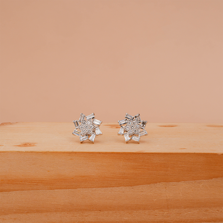 Snowflake-inspired stud earrings with baguette and round Diamonds