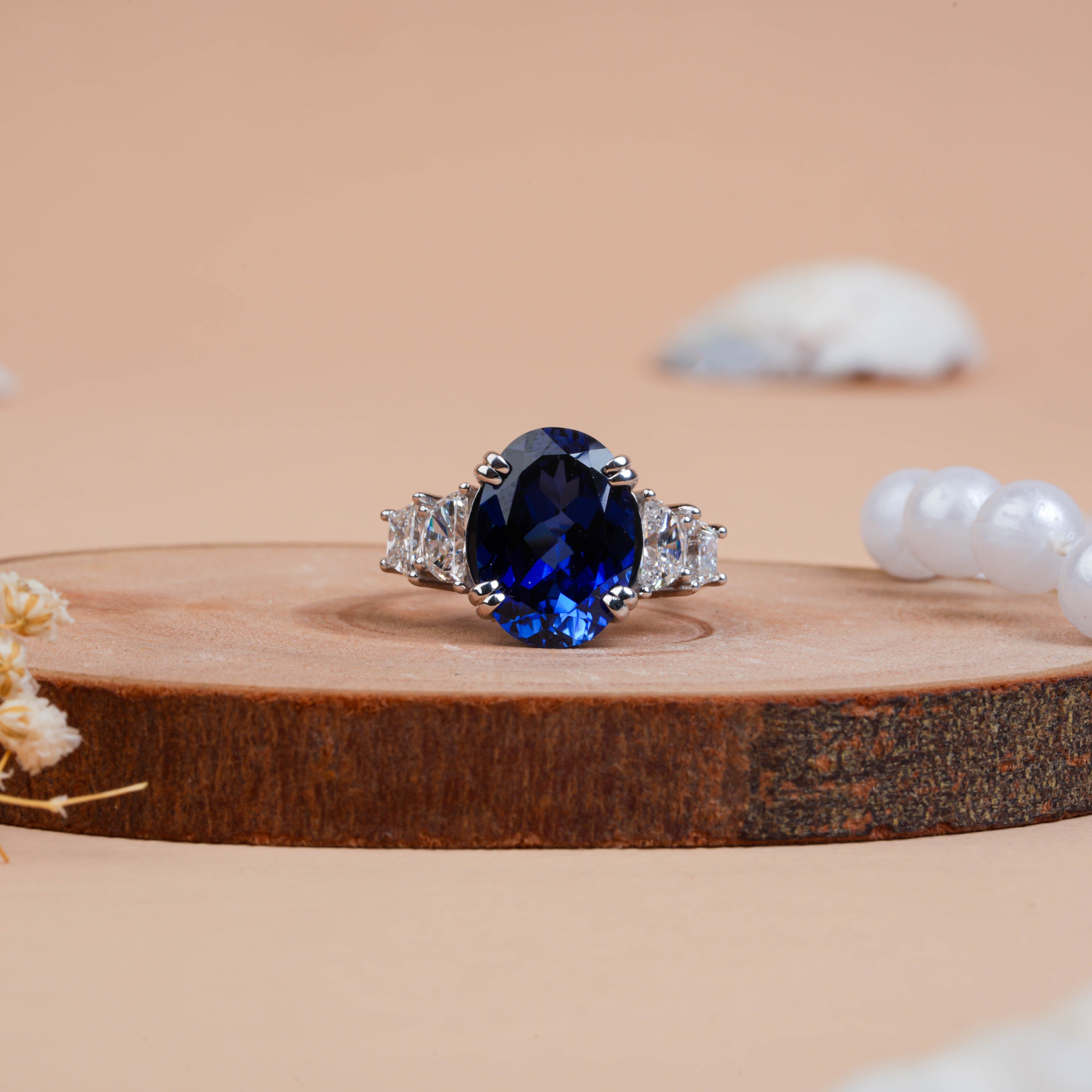 Fancy Oval Cut Blue Sapphire and Trapezoid Diamond Side-stone Ring