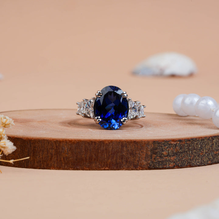 Fancy Oval Cut Blue Sapphire and Trapezoid Diamond Side-stone Ring