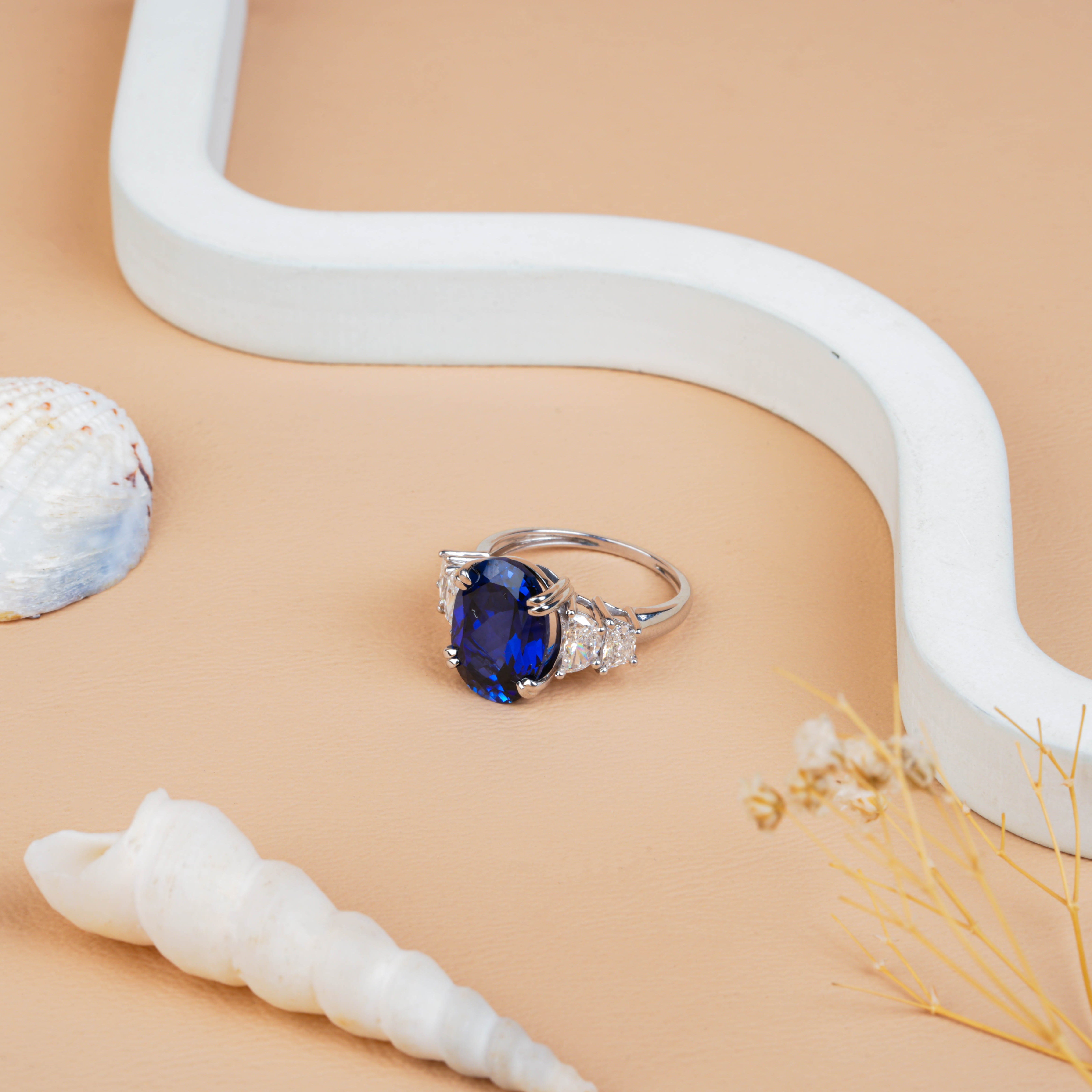 Fancy Oval Cut Blue Sapphire and Trapezoid Diamond Side-stone Ring