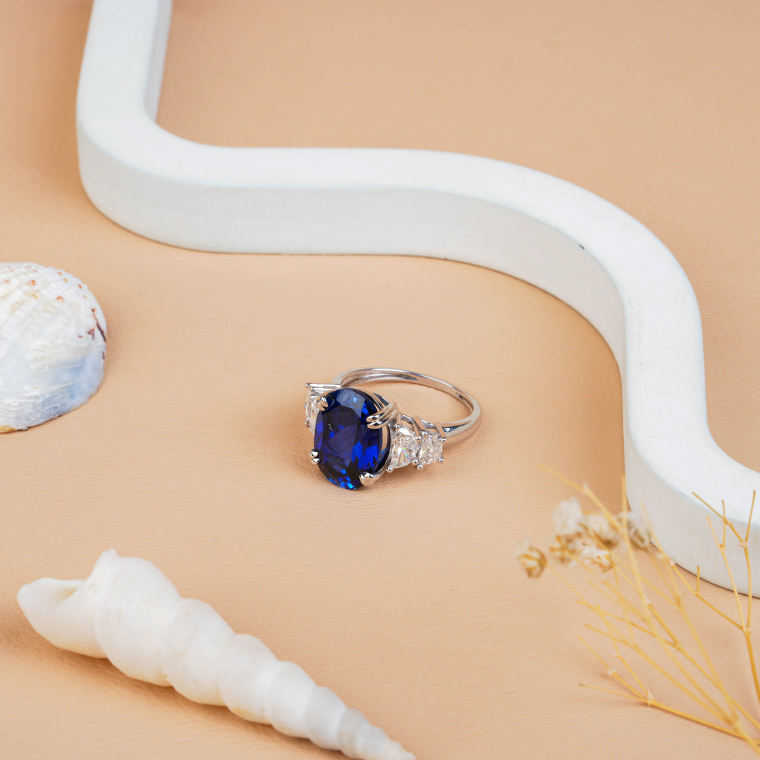 Fancy Oval Cut Blue Sapphire and Trapezoid Diamond Side-stone Ring